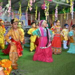 Group of girls dressed as Gopis performing a traditional dance around Krishna on Janmashtami